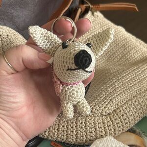The Sak Cream Crochet Dog Keychain with Pink Collar Accent